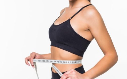 cropped-young-fitness-woman-measure-with-tape-her-belly-isolated-white-wall-min-scaled-1.jpg